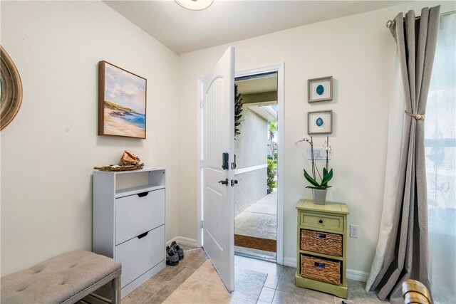 doorway with light tile patterned floors