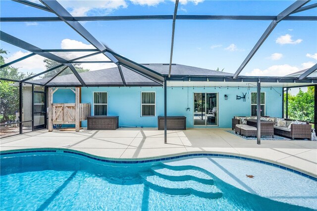 view of swimming pool with glass enclosure, a patio, and an outdoor hangout area