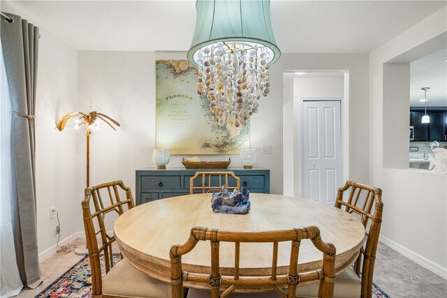 dining room featuring light tile patterned flooring and a chandelier