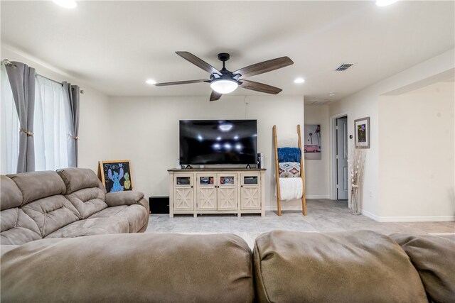 carpeted living room featuring ceiling fan