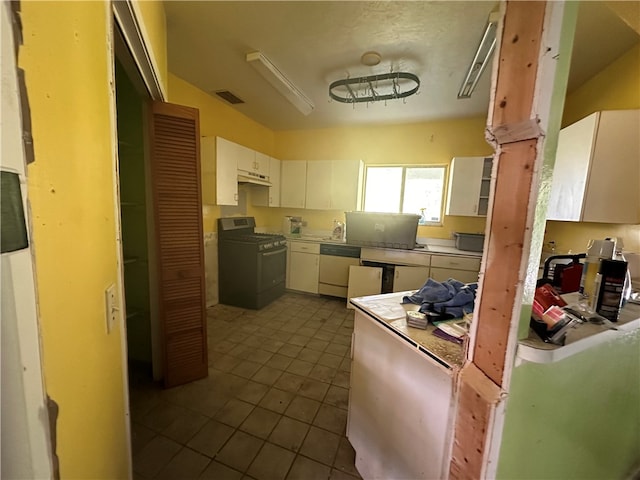 kitchen with white cabinetry, tile patterned flooring, black gas stove, and white dishwasher