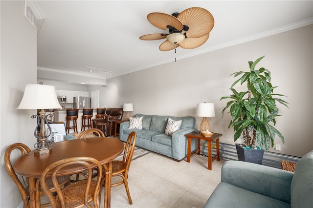 tiled living room featuring track lighting, ceiling fan, and crown molding