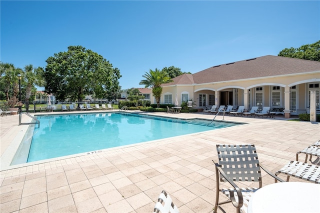 view of swimming pool featuring a patio and french doors