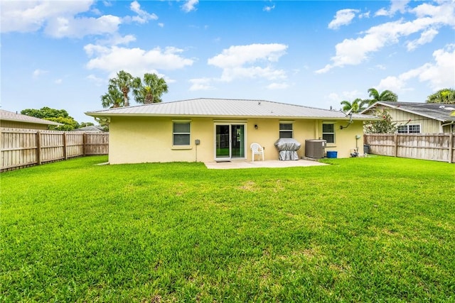 226 21st Ave, Vero Beach, FL 32962 - back of house featuring stucco siding, cooling unit, a patio area, and metal roof