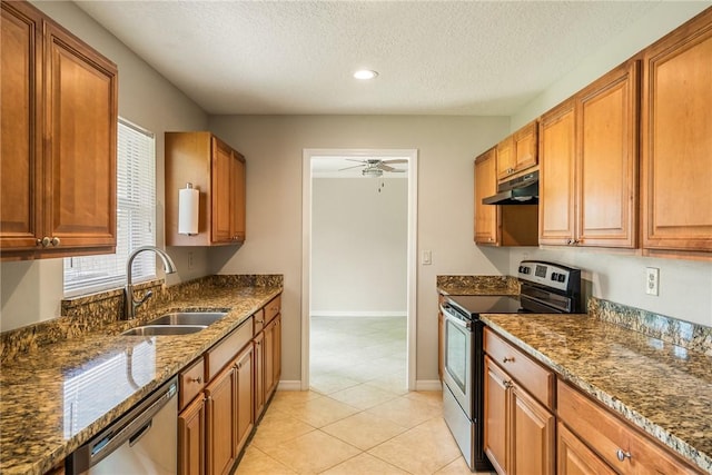 226 21st Ave, Vero Beach, FL 32962 - kitchen featuring stainless steel appliances, a sink, under cabinet range hood, ceiling fan, and dark stone countertops