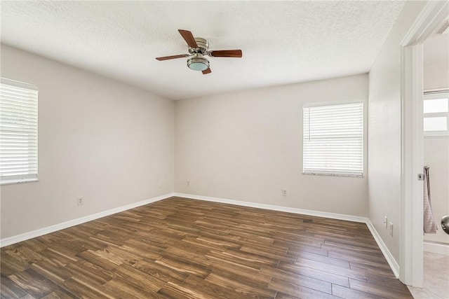 226 21st Ave, Vero Beach, FL 32962 - empty room featuring a ceiling fan, wood finished floors, healthy amount of natural light, a textured ceiling, and baseboards