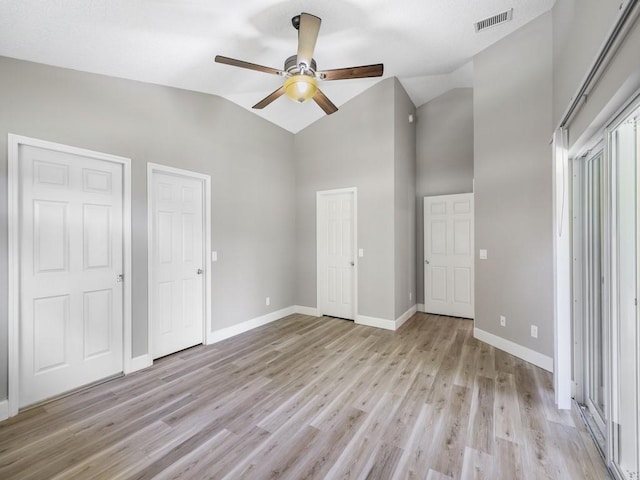 508 Calamondin Way SW, Vero Beach, FL 32968 - unfurnished bedroom featuring visible vents, baseboards, high vaulted ceiling, and light wood-type flooring