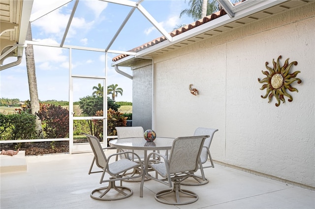 view of patio / terrace featuring glass enclosure