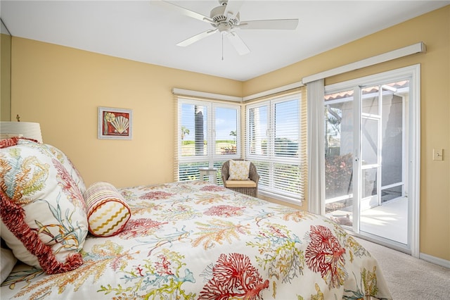 carpeted bedroom with access to exterior, ceiling fan, and multiple windows