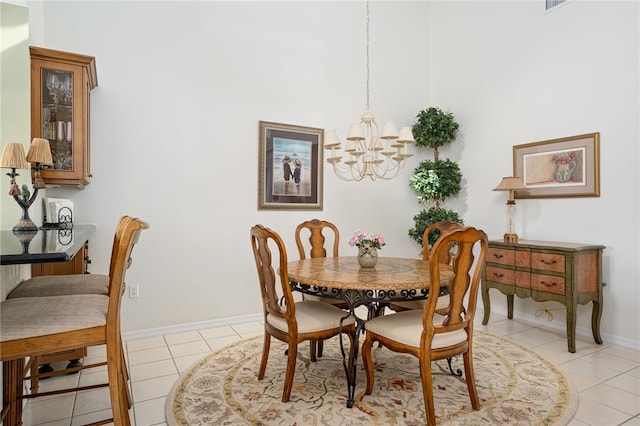 dining area with light tile patterned floors and an inviting chandelier