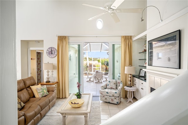 tiled living room with ceiling fan and a towering ceiling