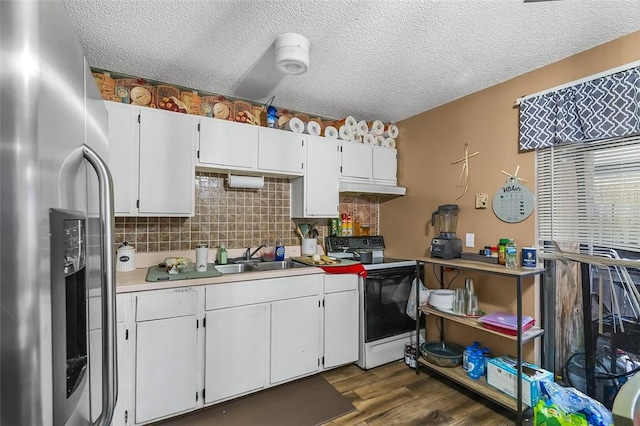 kitchen featuring sink, white cabinets, electric range, stainless steel fridge with ice dispenser, and a textured ceiling