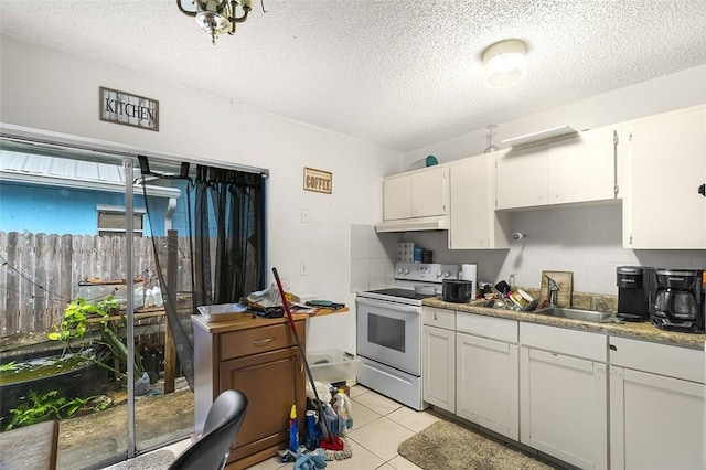 kitchen featuring light tile patterned floors, sink, white cabinetry, white range with electric stovetop, and tasteful backsplash