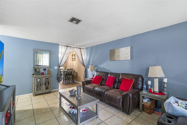 living room featuring light tile patterned flooring and a textured ceiling