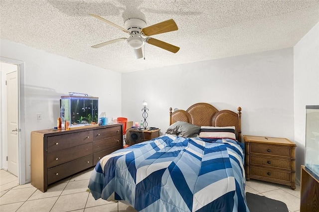 tiled bedroom with a textured ceiling and ceiling fan