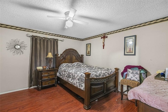 bedroom featuring dark hardwood / wood-style flooring, a textured ceiling, and ceiling fan