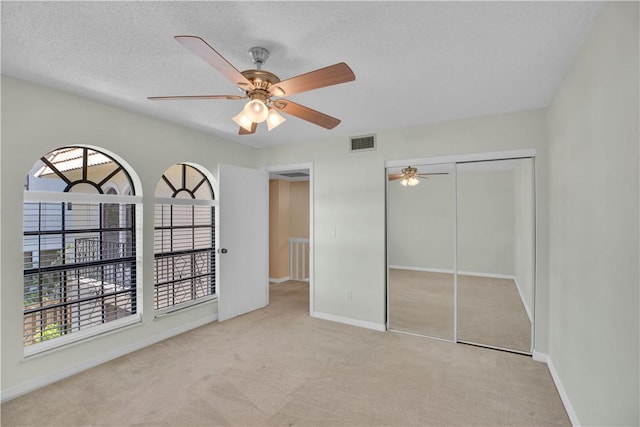 1011 Royal Palm Blvd Unit B3, Vero Beach, FL 32960 - unfurnished bedroom with carpet flooring, a closet, and ceiling fan