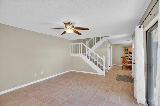 1011 Royal Palm Blvd Unit B3, Vero Beach, FL 32960 - foyer entrance featuring stairs, a ceiling fan, light tile patterned floors, and a textured ceiling