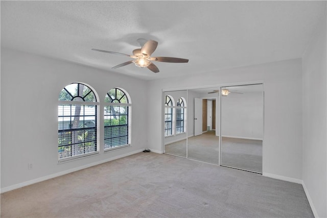 1011 Royal Palm Blvd Unit B3, Vero Beach, FL 32960 - unfurnished bedroom featuring carpet floors, a ceiling fan, and a closet