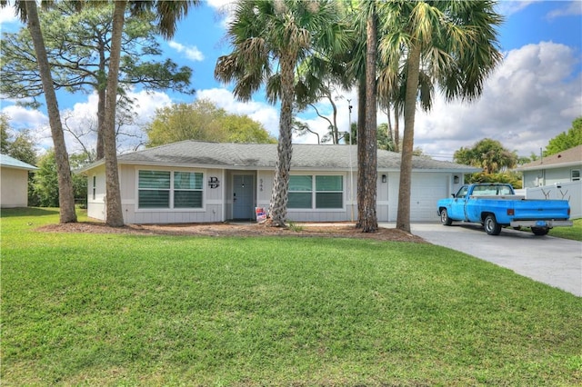 ranch-style home featuring a garage, concrete driveway, and a front lawn