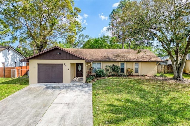 single story home with a garage and a front lawn