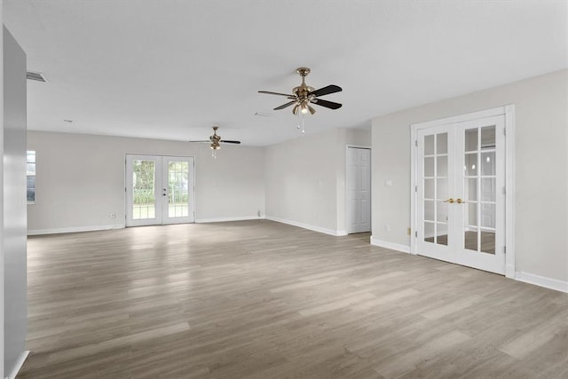 spare room featuring french doors, ceiling fan, and light hardwood / wood-style flooring