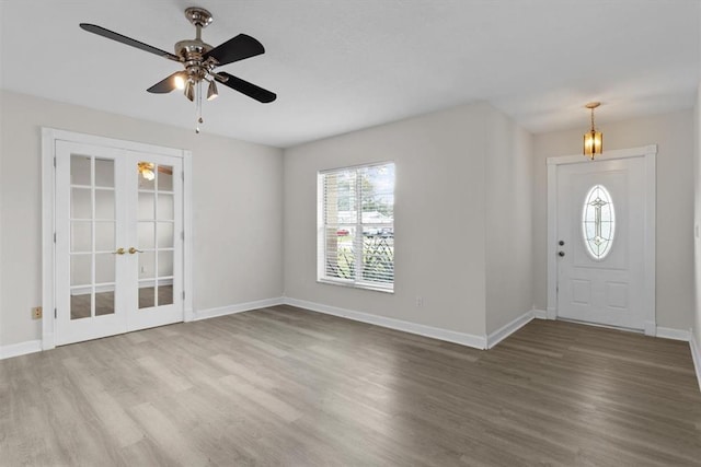 foyer entrance with wood-type flooring, french doors, and ceiling fan