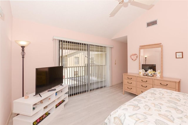 bedroom with light wood-style floors, lofted ceiling, ceiling fan, and access to exterior