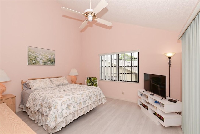 bedroom featuring wood finished floors, high vaulted ceiling, ceiling fan, baseboards, and a textured ceiling