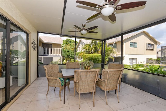 sunroom / solarium with ceiling fan and outdoor dining area