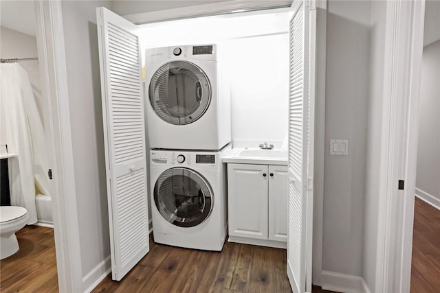 940 Turtle Cove Ln Unit 207, Vero Beach, FL 32963 - laundry room with stacked washing machine and dryer and dark wood-style flooring