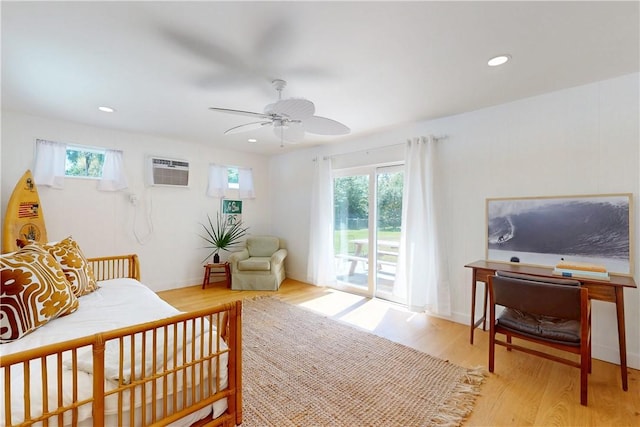 bedroom featuring ceiling fan, light wood-type flooring, access to outside, and multiple windows