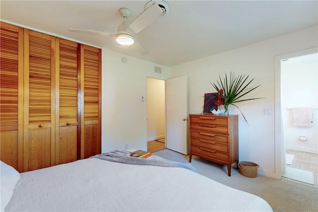 bedroom featuring a closet, ceiling fan, and light colored carpet