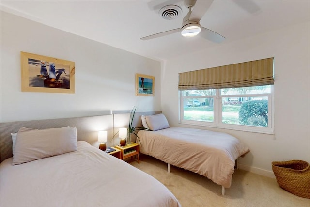 bedroom featuring light carpet and ceiling fan