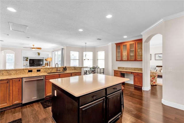 1337 Scarlet Oak Cir, Vero Beach, FL 32966 - kitchen featuring dishwasher, a sink, arched walkways, ornamental molding, and light countertops