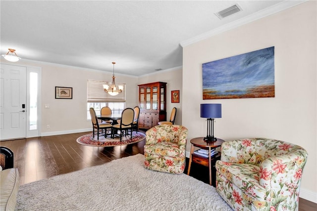 1337 Scarlet Oak Cir, Vero Beach, FL 32966 - living area with wood finished floors, a chandelier, baseboards, and crown molding