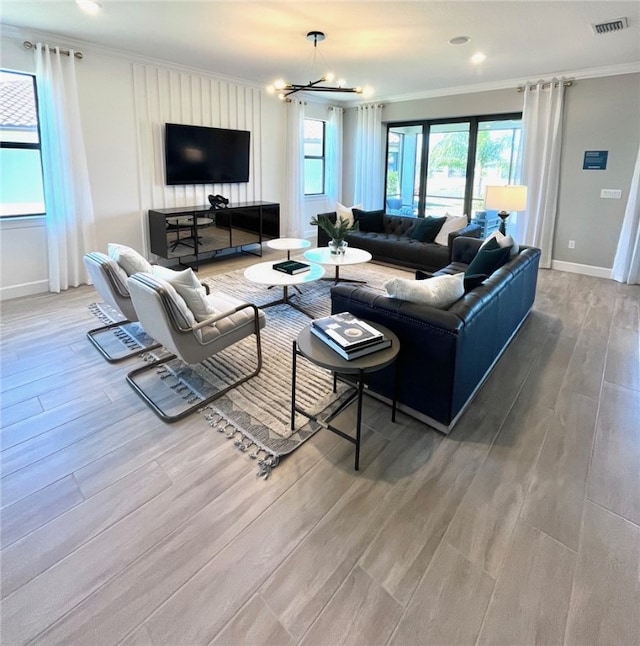 living room featuring crown molding, light wood-style flooring, baseboards, and visible vents