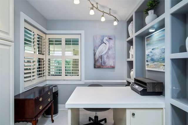 home office with built in desk, a textured ceiling, and light tile patterned floors