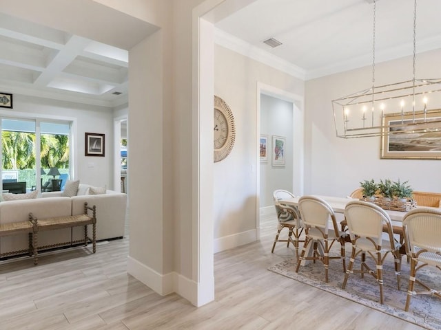 dining area featuring beam ceiling, ornamental molding, coffered ceiling, and light wood-type flooring