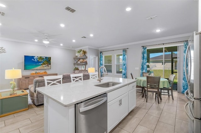 kitchen featuring a kitchen island with sink, stainless steel appliances, visible vents, white cabinets, and open floor plan