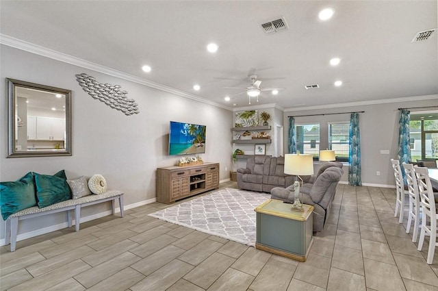 living room featuring baseboards, visible vents, and crown molding