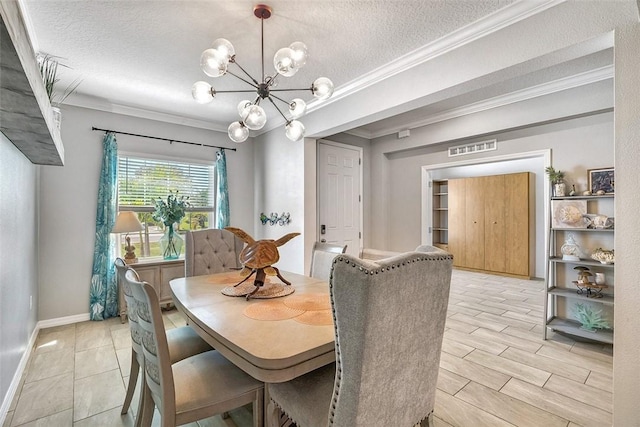 dining space featuring ornamental molding, a textured ceiling, and an inviting chandelier