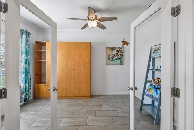 interior space featuring multiple windows, crown molding, and french doors