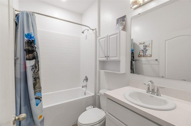 full bath with toilet, shower / tub combo with curtain, and vanity