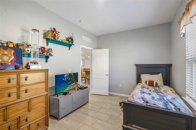 bedroom featuring visible vents, baseboards, and light tile patterned floors