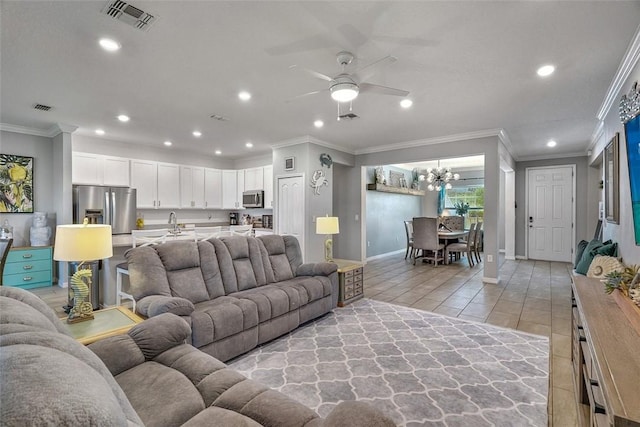 living room featuring light tile patterned floors, crown molding, visible vents, and recessed lighting