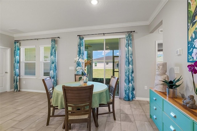 dining space with ornamental molding, plenty of natural light, and baseboards