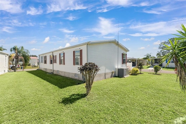 view of home's exterior with a yard, crawl space, and central air condition unit