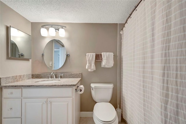 bathroom with a textured ceiling, toilet, vanity, and tile patterned floors