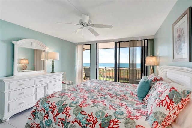 bedroom featuring a water view, access to outside, and a ceiling fan